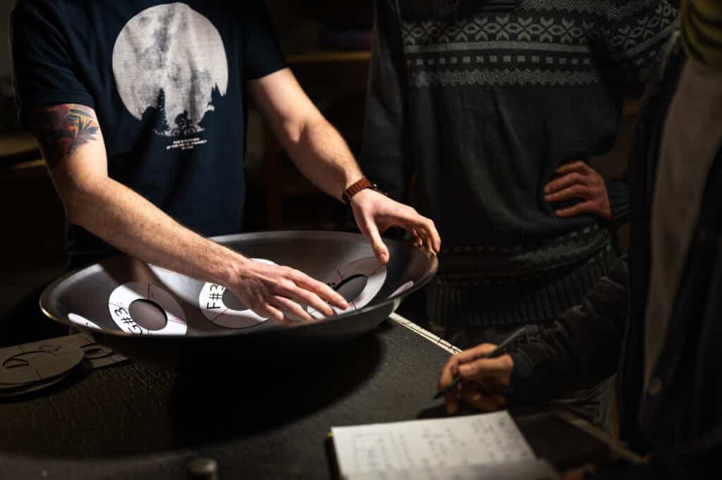 Handpan makers analysing an instrument